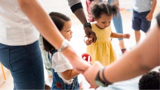 Grupo formando un círculo con las manos como símbolo de comunidad educativa
